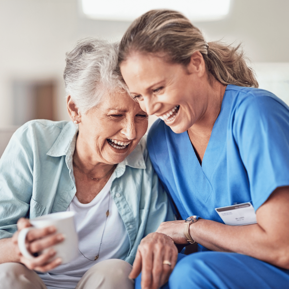 Caregiver helping with a patient lift transfer